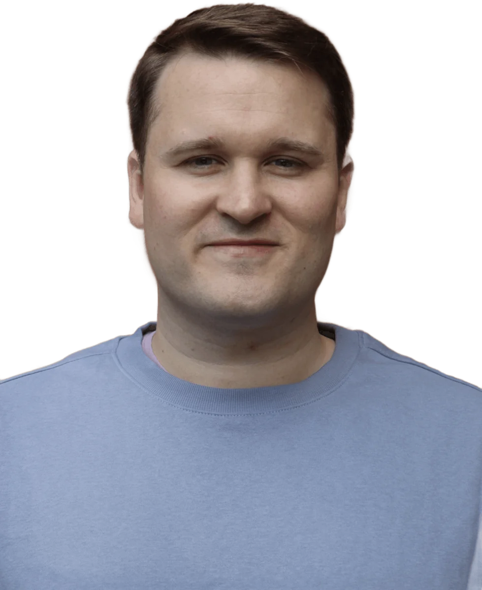 Samuel Moult smiling, in a blue sweater